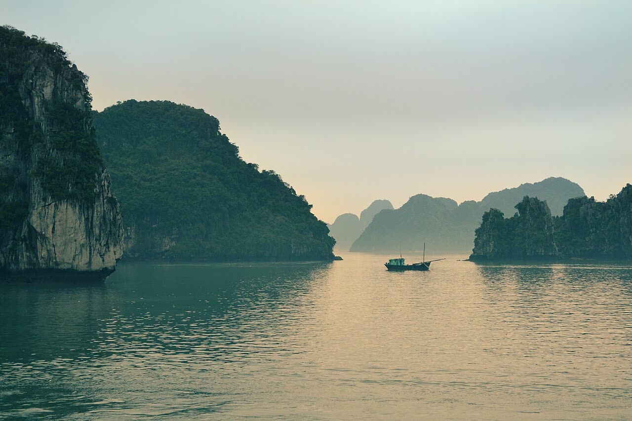 A boat among the limestone islands of Ha Long Bay