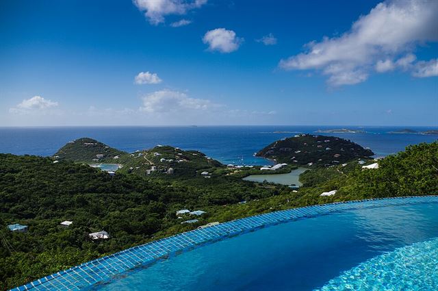 An infinity pool above a bay of green islands