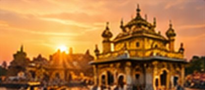 A golden temple on the water at sunset