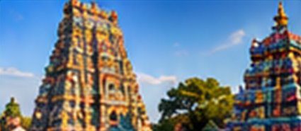 Painted temple gopurams against a blue sky