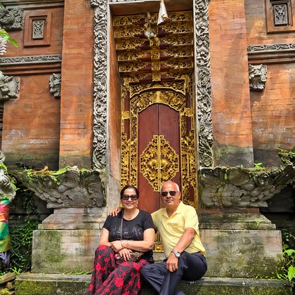 Our travellers on the steps of a carved golden door in Bali