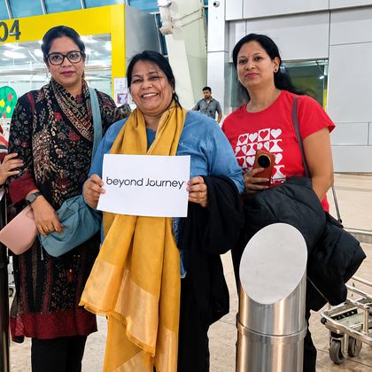 Our Goa travellers holding a Beyond Journey sign at the airport