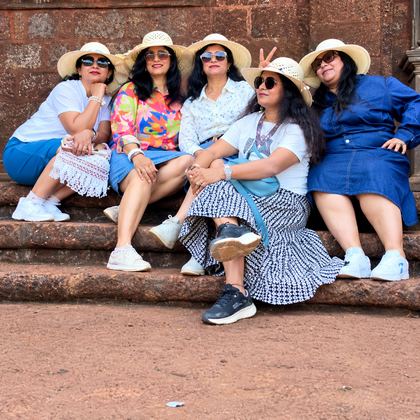 Our travellers in sun hats on old laterite steps in Goa