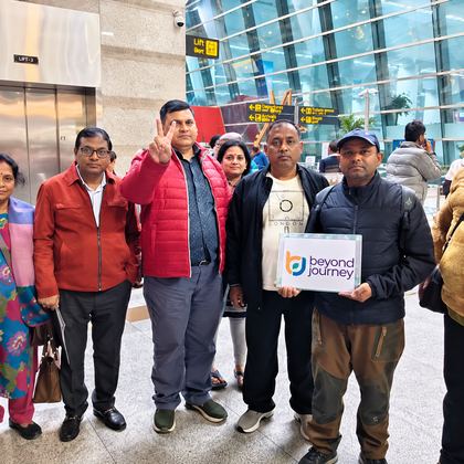 Our Sri Lanka travellers holding a Beyond Journey sign at the airport
