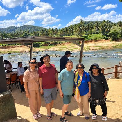 Our travellers by a palm-lined river in Sri Lanka