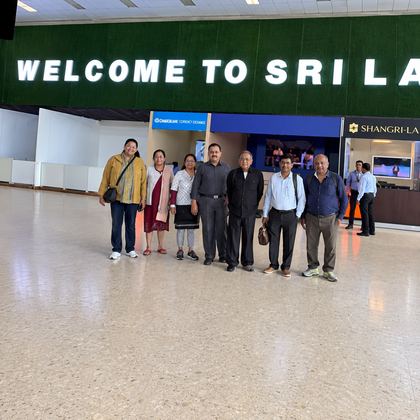 Our travellers under the Welcome to Sri Lanka sign on arrival