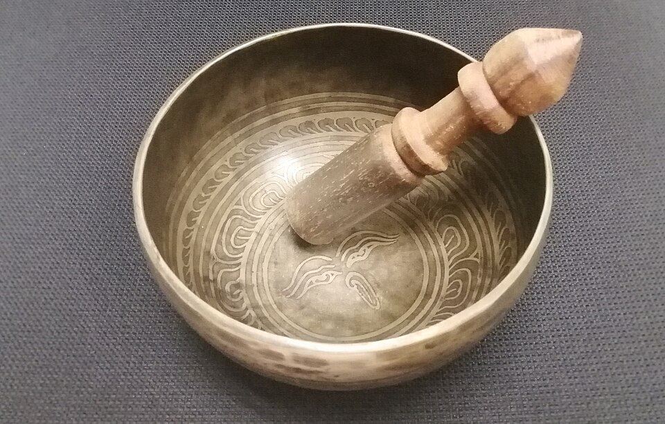 A Tibetan singing bowl and its striker