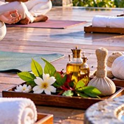 Herbal compresses, oils and towels laid out for a spa treatment