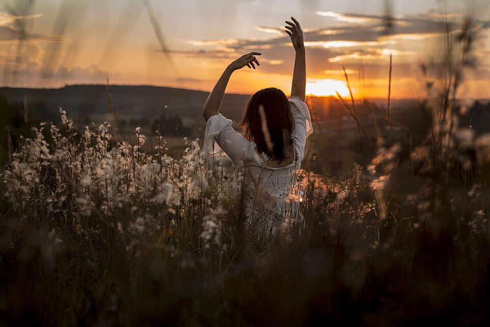 A woman in a yoga pose at sunrise